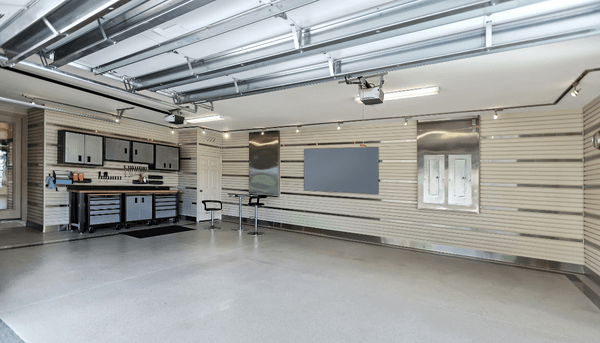 Organized garage with storage cabinets, workbench, and wall-mounted tools for efficient space use.