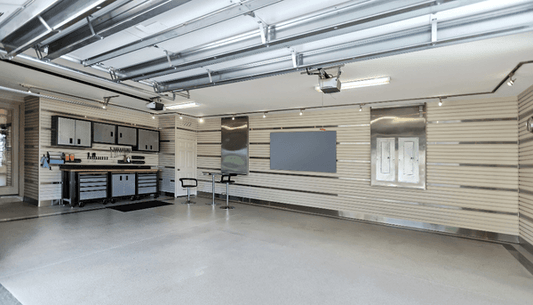 Organized garage with storage cabinets, workbench, and wall-mounted tools for efficient space use.