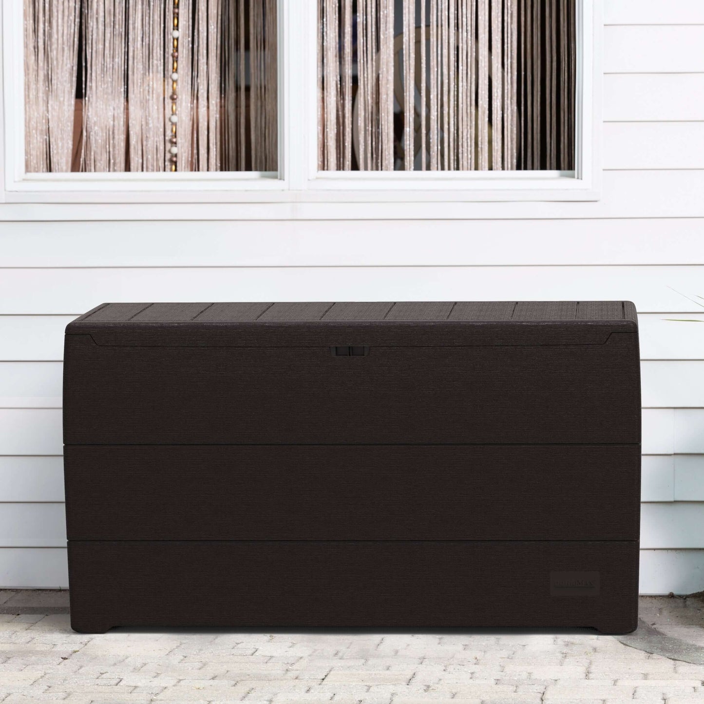 Duramax 71 Gallon Deck Box in Brown, perfect for outdoor storage and seating, placed against a white wall.