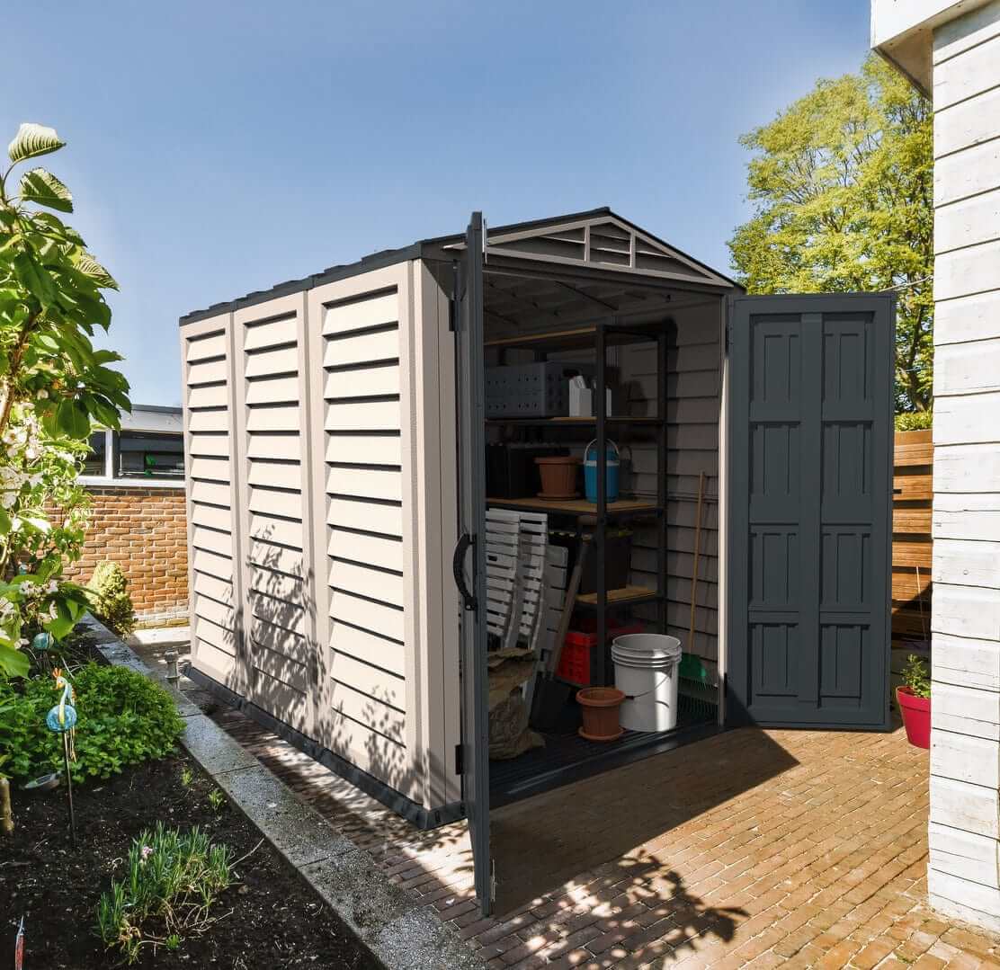 Duramax Vinyl Shed 5x8 YardMate Plus shown in garden, offering spacious outdoor storage solution.