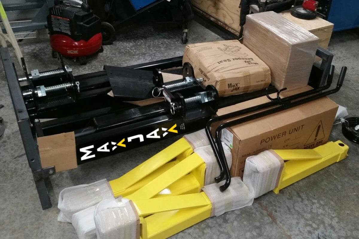 MaxJax M7K 2 Post Car Lift components, showcasing the portable lift and power unit in packaging.