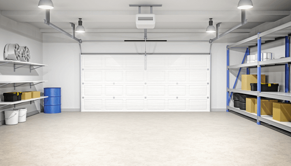 Spacious and organized garage interior with shelves, storage bins, and a garage door.