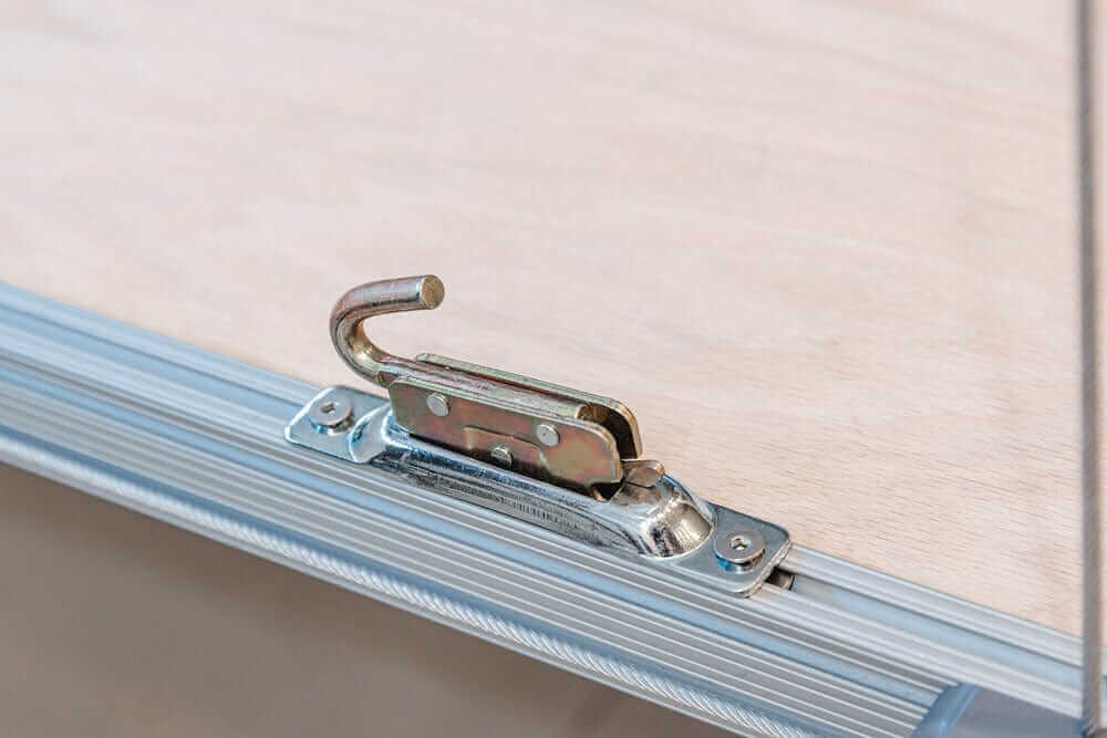 Close-up of Auxx Lift hook mechanism for efficient and secure attic storage solutions.