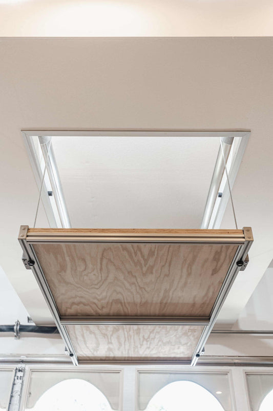 Auxx Attic Lift fully extended, showcasing motorized garage storage lift system for easy access to attic space. 