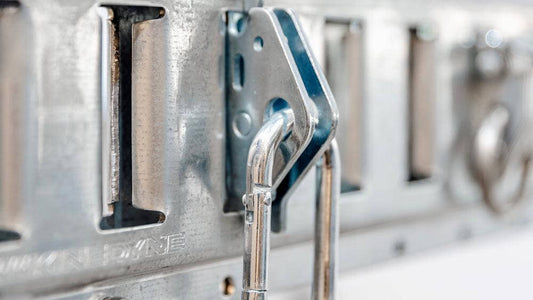 Close-up of Auxx Lift carabiner snap-in anchor, designed for load securing with a 1,500 lbs capacity. 