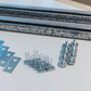 Auxx Lift platform rotation hardware kit components including brackets, springs, and fasteners for installation.