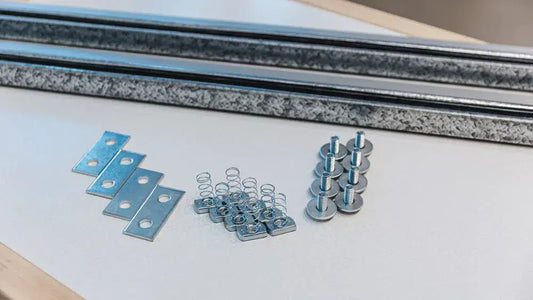 Auxx Lift platform rotation hardware kit components including brackets, springs, and fasteners for installation. 