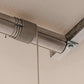 Close-up of the Auxx Lift's motorized storage lift cable system mounted on a garage ceiling.