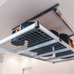 Auxx Lift motorized garage storage lift holding storage containers overhead in modern garage.