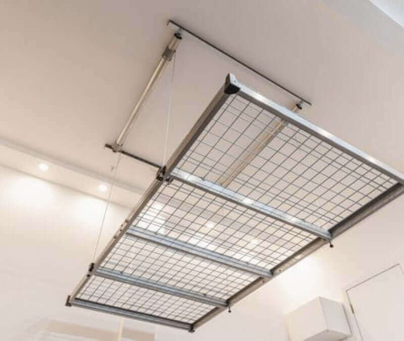 Auxx Lift motorized garage storage lift shown mounted on ceiling for efficient overhead storage.