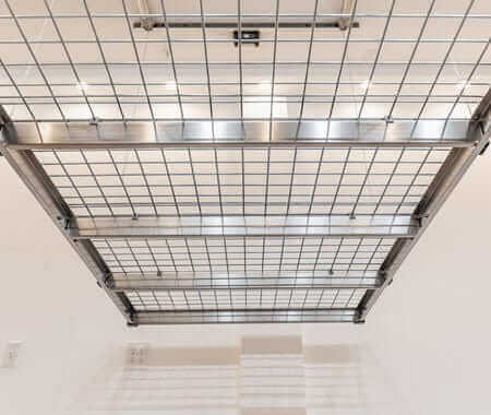 Auxx Lift motorized garage storage lift ceiling view, showcasing sturdy grid design for elevated storage solutions.