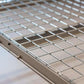 Close-up of the sturdy metal grid platform of the Auxx Lift, showcasing durable design for motorized garage storage.