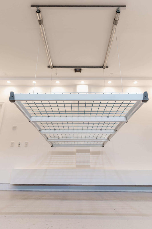 Auxx Lift motorized garage storage lift showcasing a platform storage system installed overhead. 