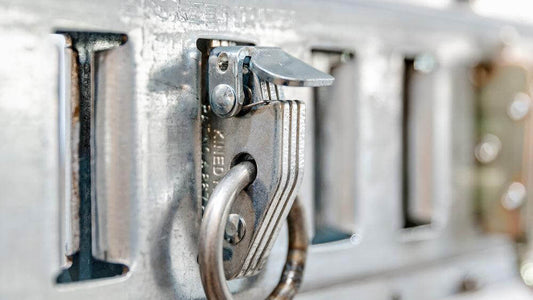 Close-up of Auxx Lift round ring snap-in anchor for versatile load securing with track and accessories. 