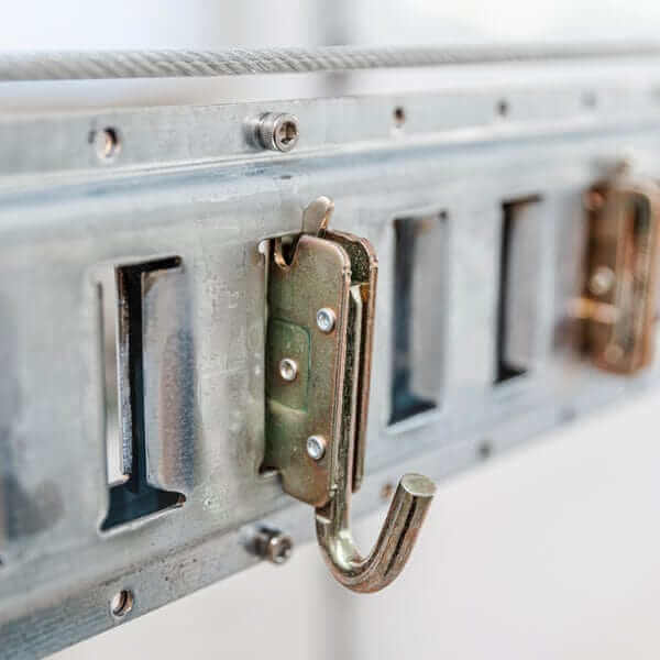 Close-up of Auxx-One lift hardware showing hooks and metal rail for secure garage storage.