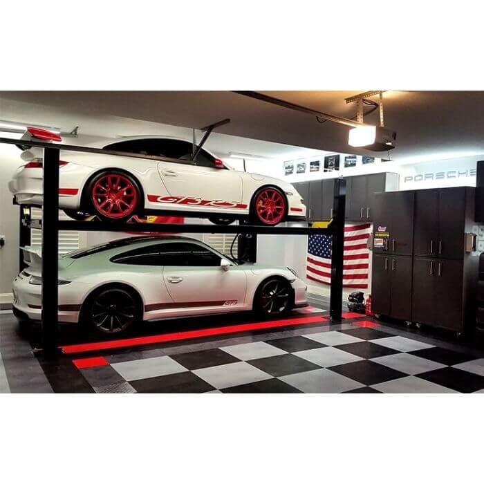 BendPak HD-7W car lift elevating two Porsches in a sleek garage with checkered flooring and American flag.