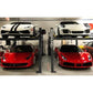 BendPak HD-7W four post car lift with sports cars: two red Ferraris and one white Porsche on top.