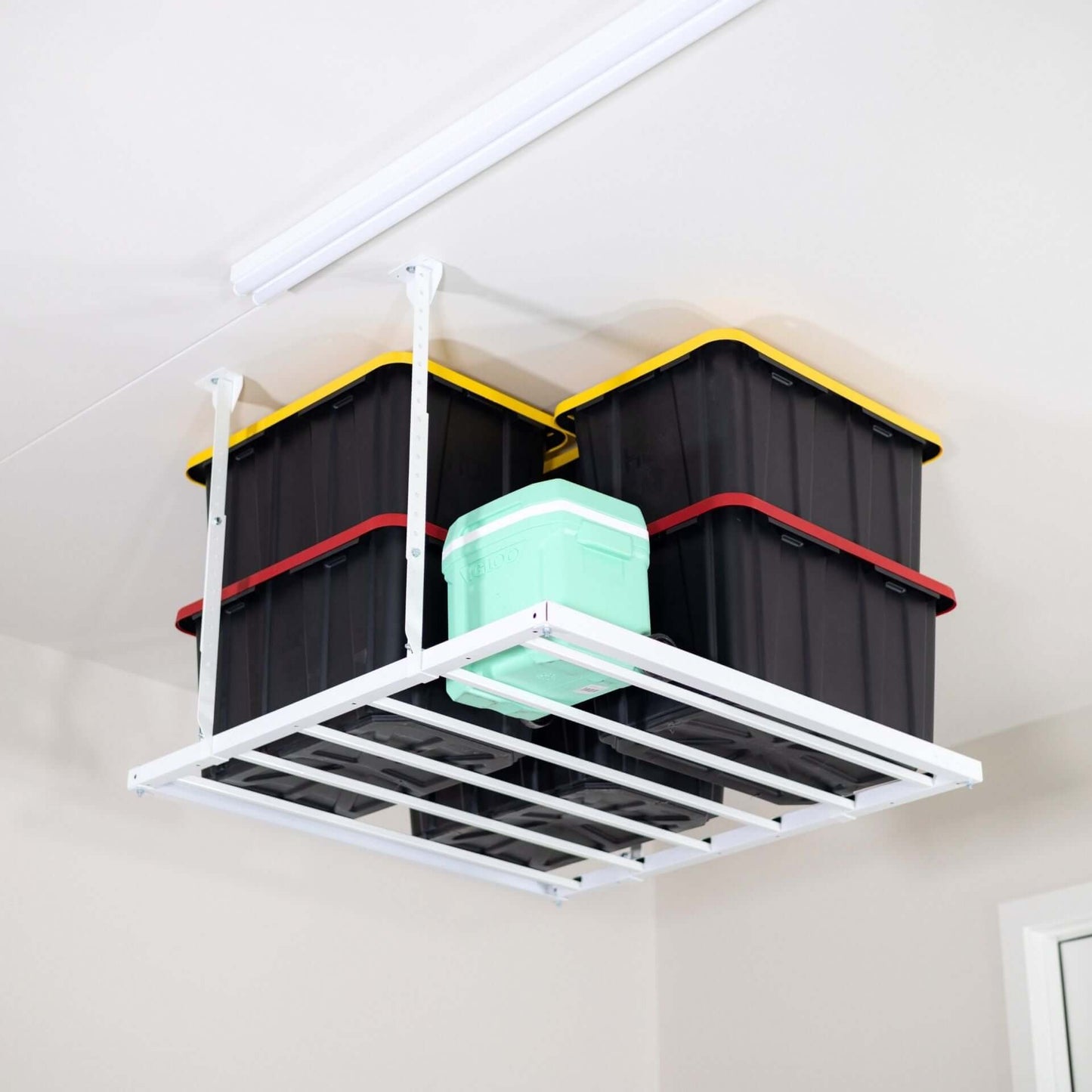 Ceiling Sam 400 lbs 4x4 Garage Ceiling Storage with stacked storage bins suspended from the ceiling.