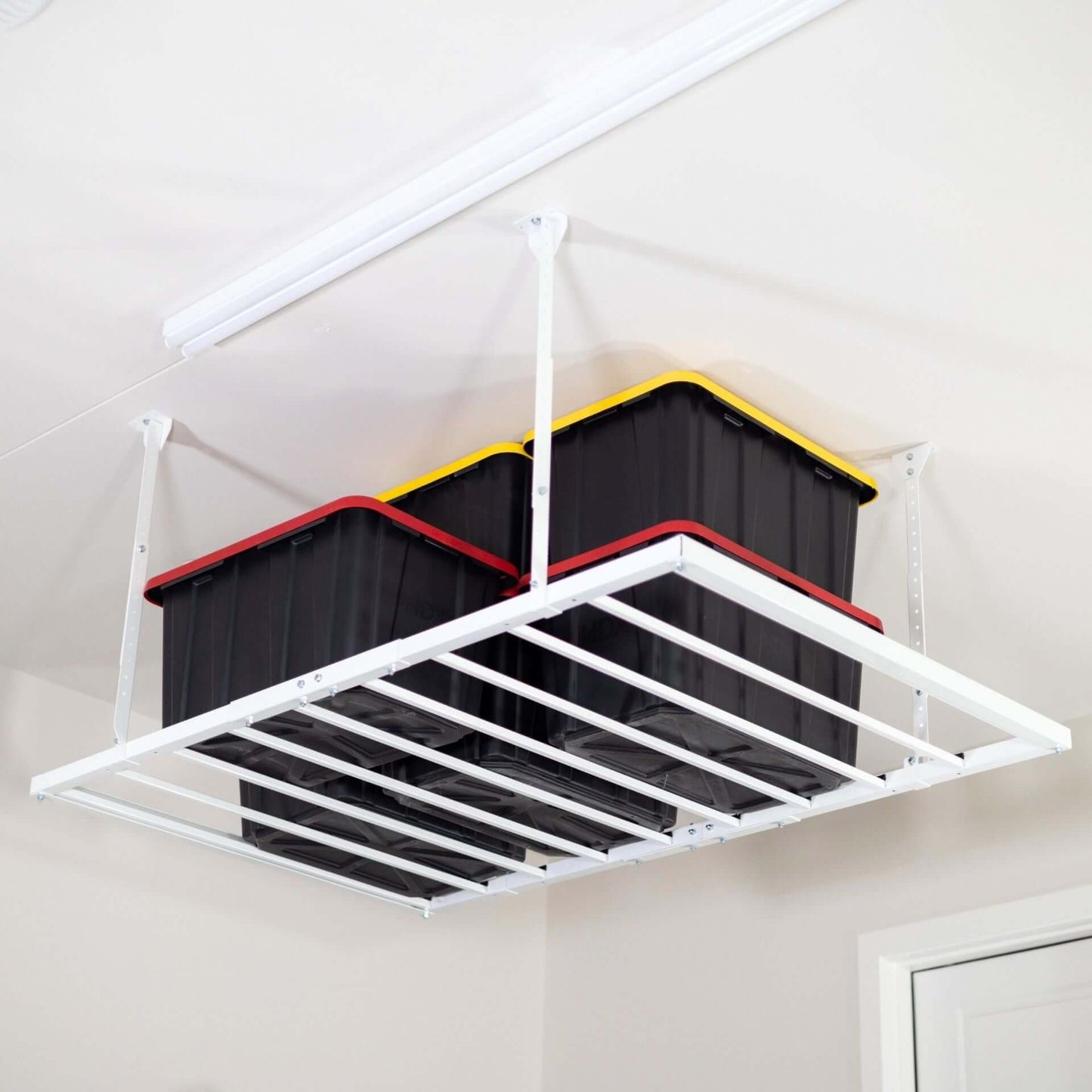Ceiling Sam 600 lbs 4x6 Garage Ceiling Storage with black and colored bins overhead.
