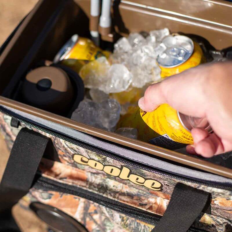 A person retrieving a cold drink from a Coolee CL-240 ice-chest filled with ice and beverages.