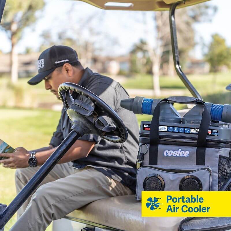 Man enjoying a portable air cooler Coolee CL-240 on a golf cart, combining cooling and convenience outdoors.