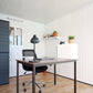 Interior view of a modern home office setup in a Duramax garden room with a desk and plants.