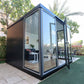 Duramax 10x10 Glass Garden Room 32001, modern black structure with glass walls, ideal for garden office or playroom.