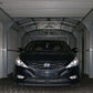 Black Hyundai sedan parked in a Duramax 12x20 Imperial Metal Garage with an industrial interior.