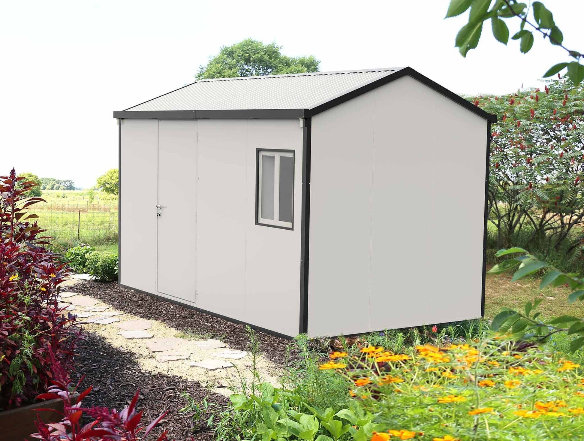 Duramax 13x10 insulated gable roof building in a garden setting, featuring a white exterior and window.