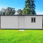 Duramax 22x10 insulated building with flat roof, featuring a door and window, set in a green lawn.