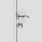 Modern chrome door handle with keyhole on white door, showcasing sleek design and security features.