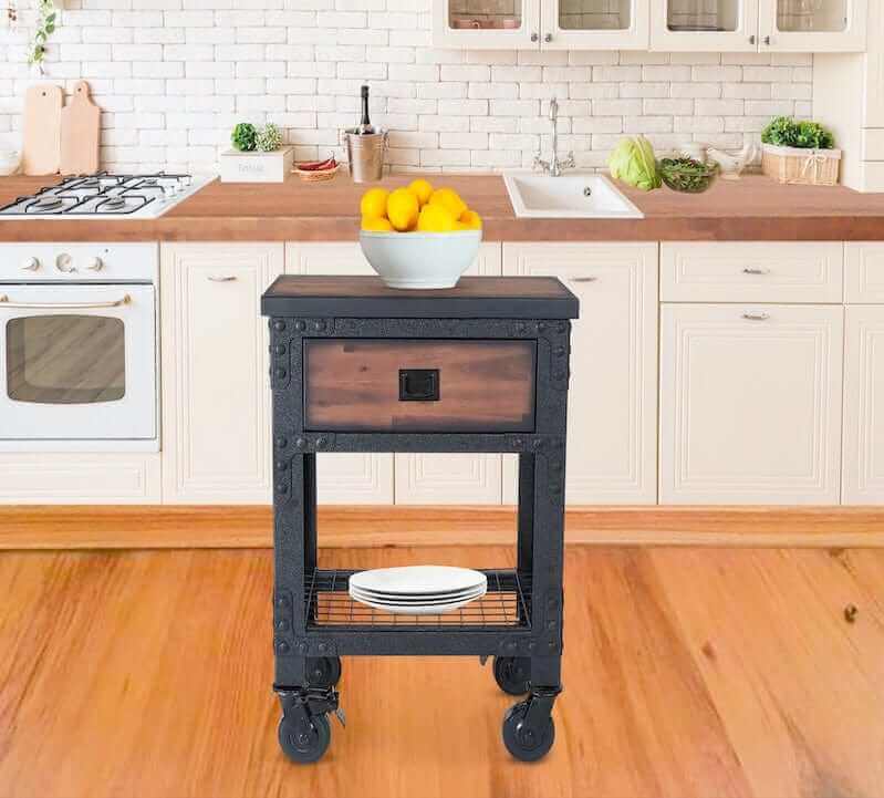 Rolling industrial workbench with drawer and shelf in a kitchen, styled with fruit and plates, showcasing functionality and design.