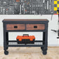 Duramax 48x24 2-drawer rolling industrial workbench with tools in the background, suitable for workshops and garages.