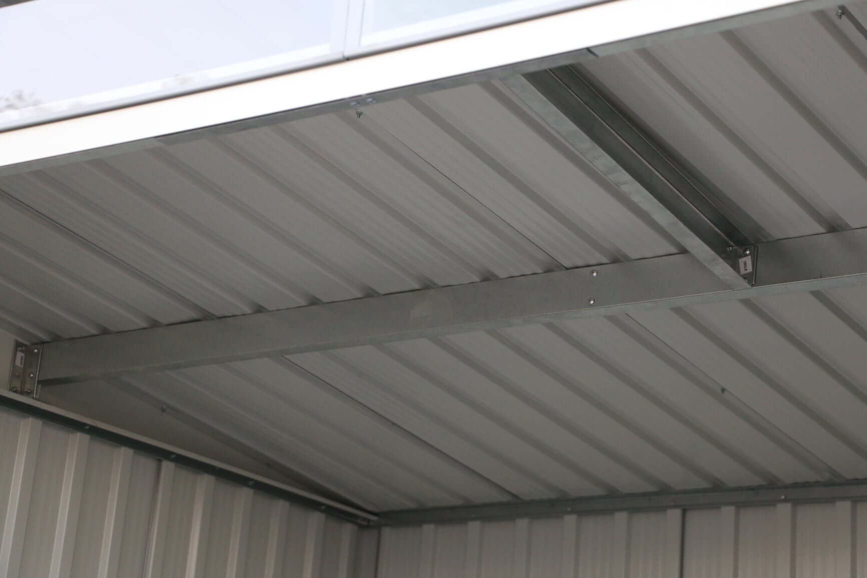 Interior view of Duramax 8x6 metal shed pent roof showing sturdy roof structure and skylight design.