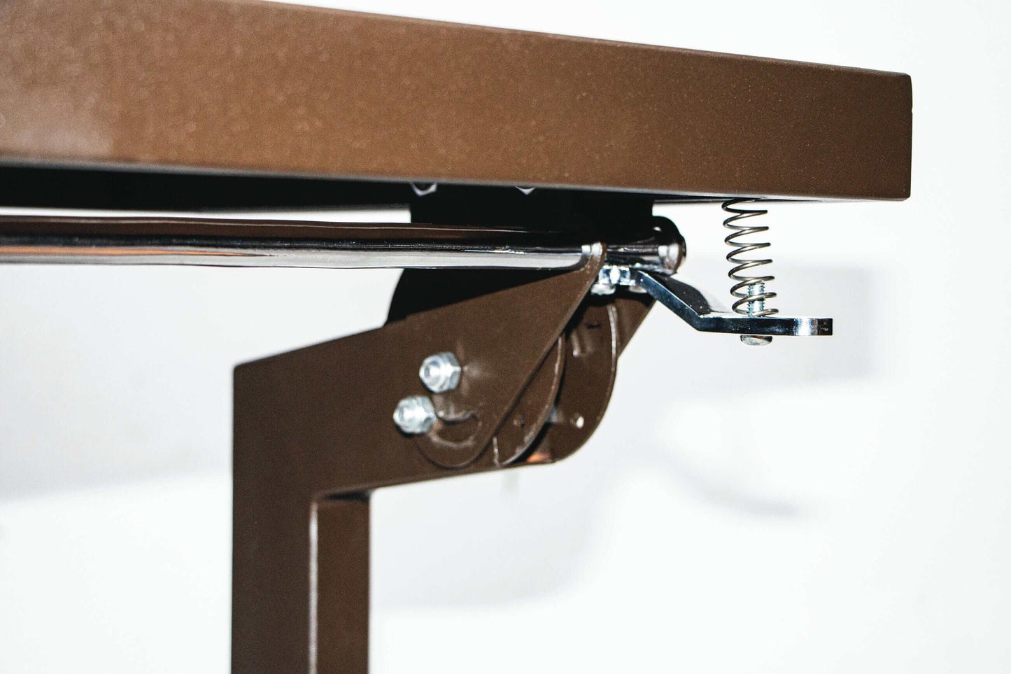 Close-up of the Duramax Ashton Convertible Table Bench 68070's sturdy metal hinge and spring mechanism.