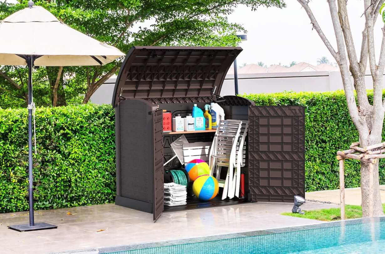 Duramax Storeaway Arc Lid 1200L garden shed in brown, showcasing organized outdoor storage by the pool.