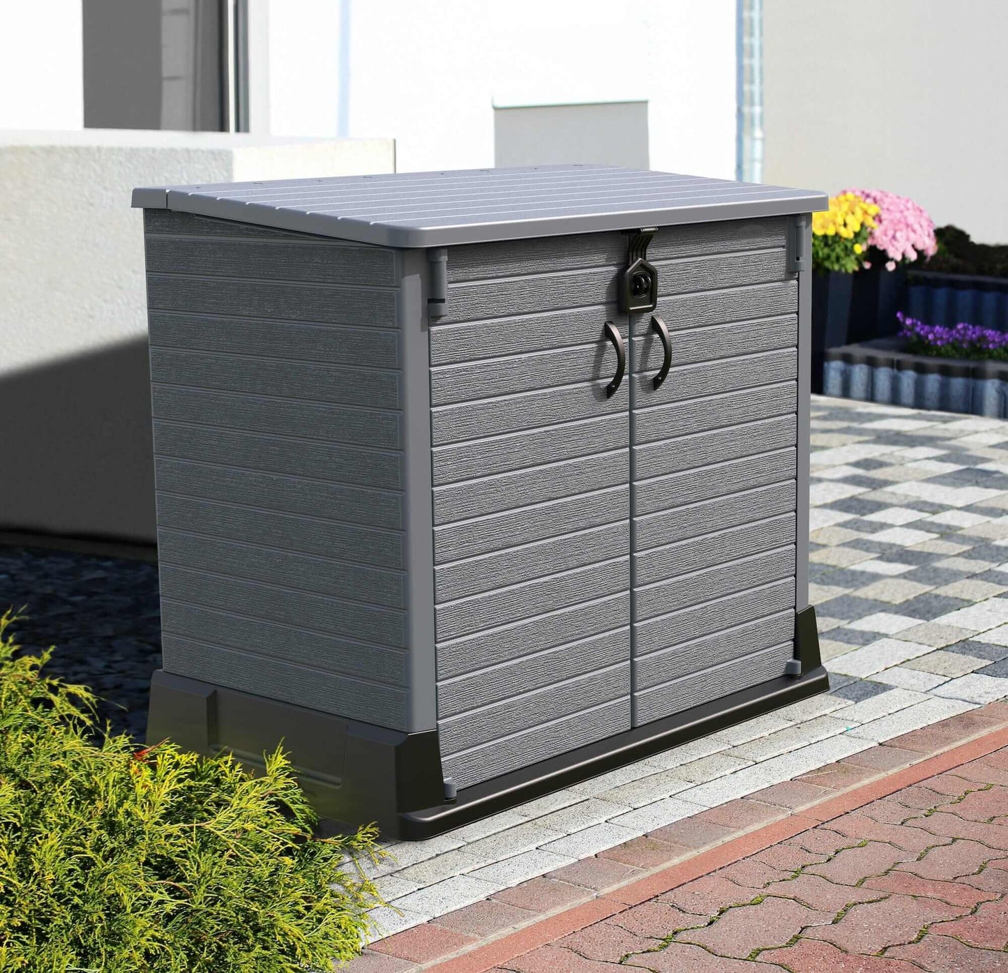 Duramax Storeaway Flat Lid 1200L Gray outdoor storage shed with double doors on a pathway.