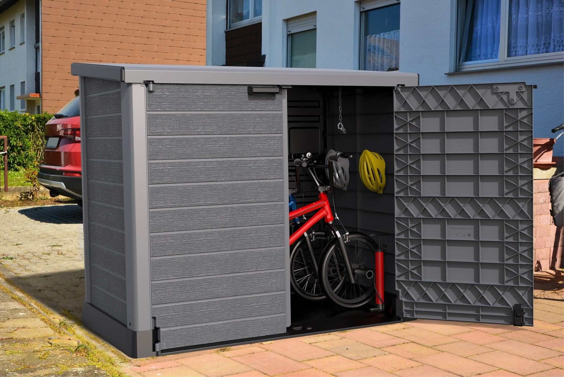 Duramax Storeaway Flat Lid 1200L Gray shed with bicycle and helmet stored inside.