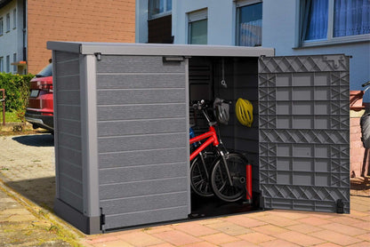 Duramax Storeaway Flat Lid 1200L Gray shed with bicycle and helmet stored inside.