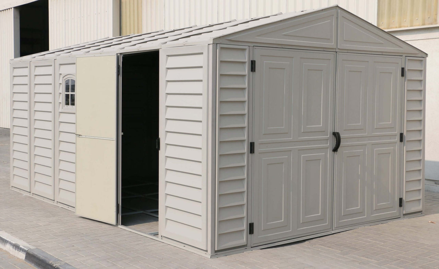 Duramax vinyl garage 10.5 x 15 with foundation, featuring a spacious interior and sturdy design for outdoor storage.