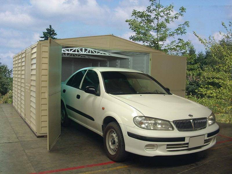 Duramax vinyl garage 10.5 x 26 with a white car parked inside, featuring open doors and a scenic background.