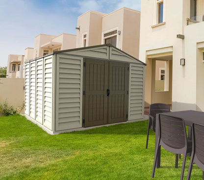 Duramax 10.5x10 Woodbridge Plus Vinyl Shed in backyard setting with lawn and patio furniture.