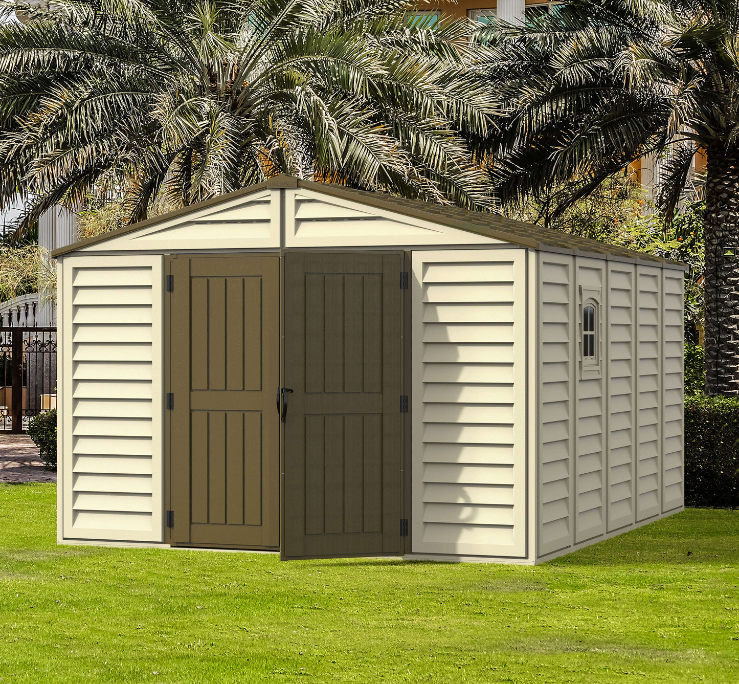 Duramax Vinyl Shed 10.5x13 Woodbridge Plus with foundation in a landscaped garden setting.