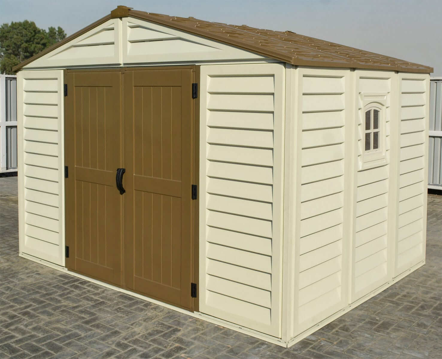 Duramax Vinyl Shed 10.5x8 Woodbridge Plus with foundation, featuring double doors and a window.