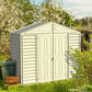 Duramax Vinyl Shed 10x3 SidePro with foundation in a garden setting, surrounded by greenery and spring flowers.