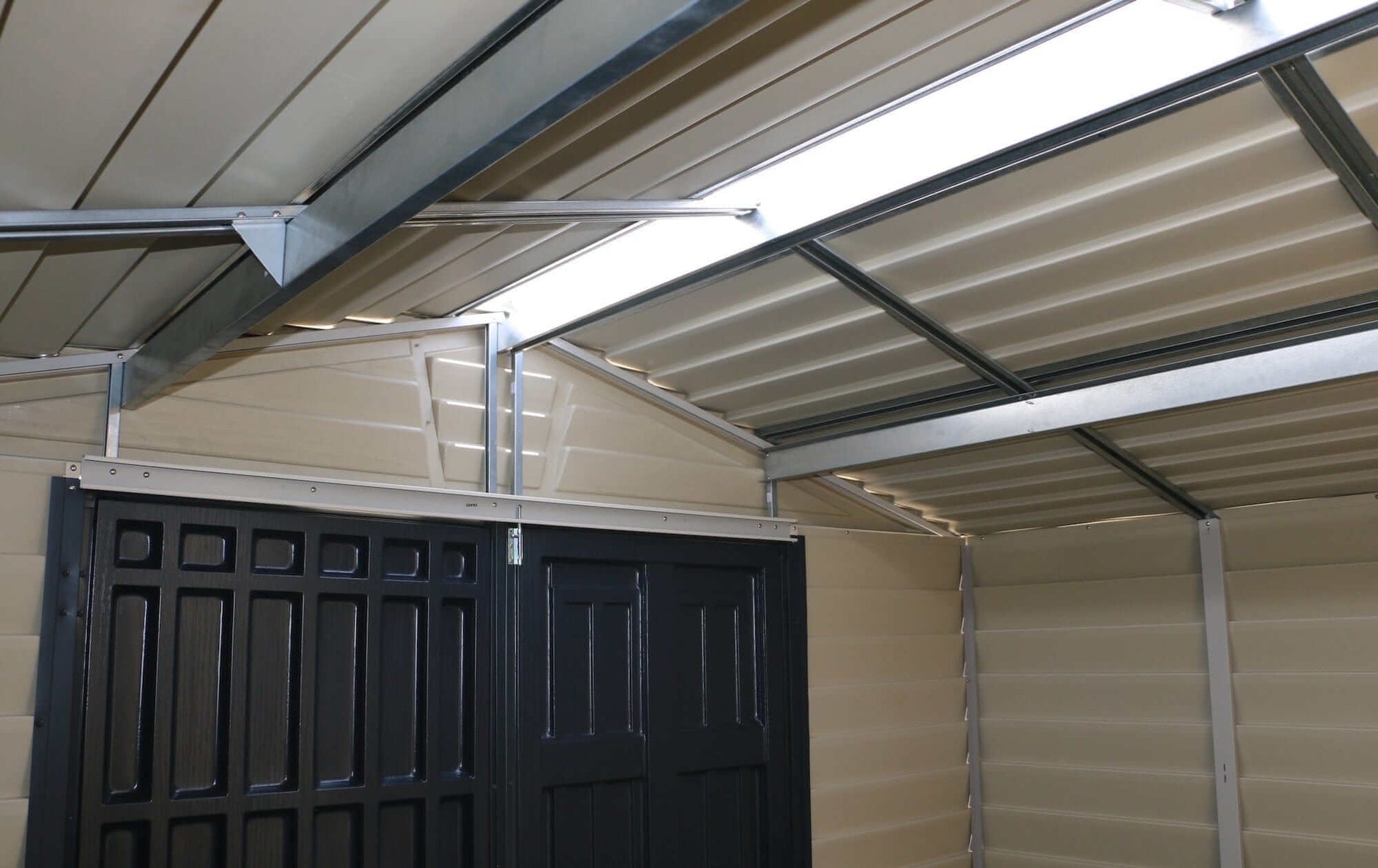 Interior view of a Duramax Vinyl Shed showcasing a sturdy roof and double door design.