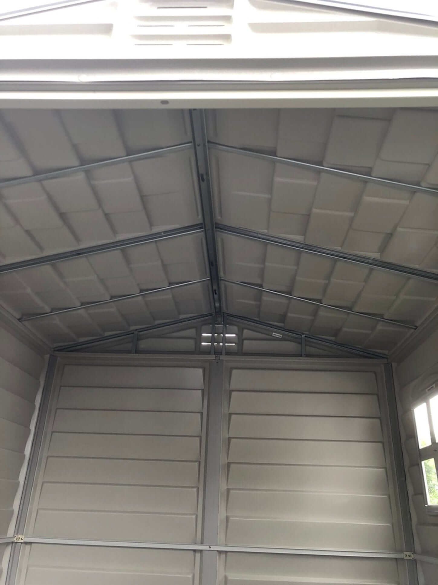 Interior view of Duramax Vinyl Shed with durable metal frame and spacious design.