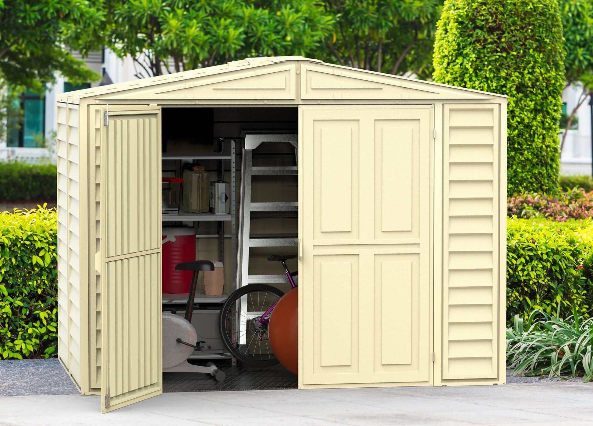 Duramax 8x6 DuraMate vinyl shed with foundation, featuring spacious storage and open doors in a landscaped backyard.