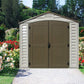 Duramax 8x8 DuraPlus vinyl shed in a colorful flower garden, featuring double doors and a classic design.