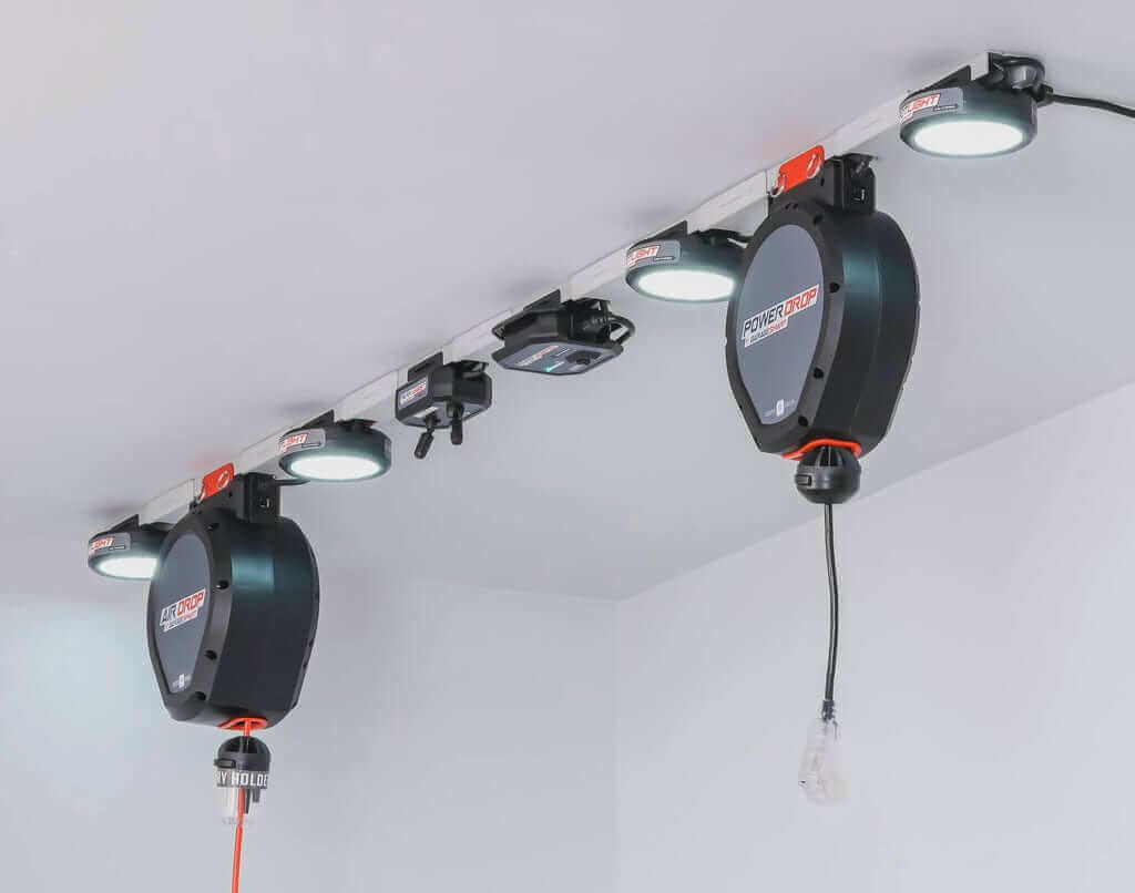 Garage Smart Power Drop with retractable cords and lights for motorized garage storage solutions.